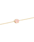 Gold bracelet with a pink flower charm on a white background